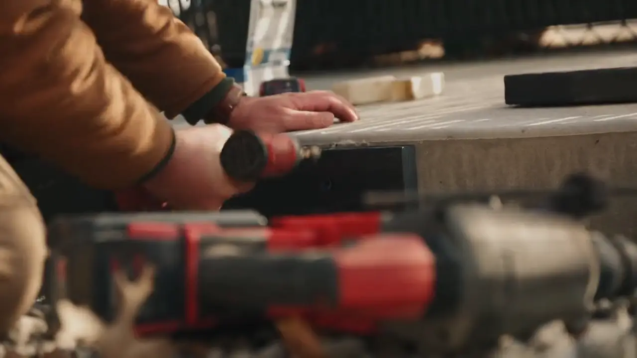Close-up of a crew member setting a hammer drill